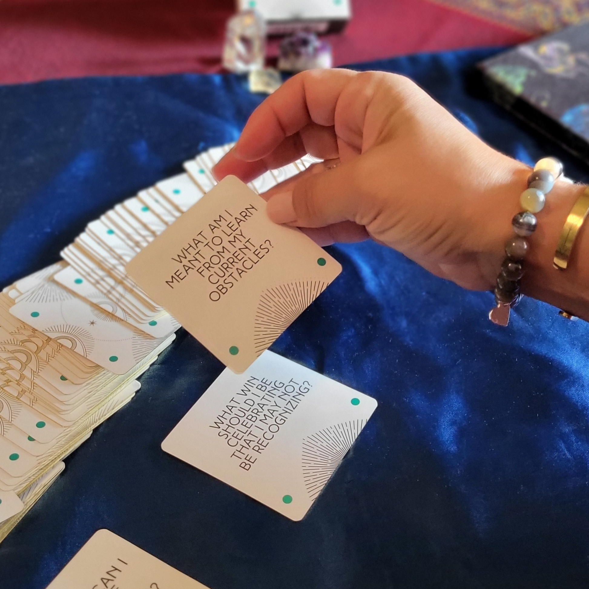 Lady selecting question cards for tarot spread.